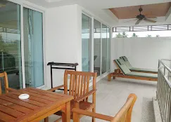 Family swimming pool area surrounded by palm trees